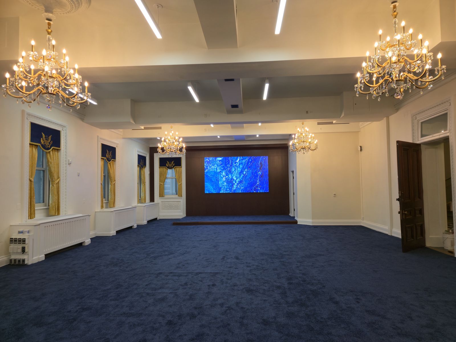 After: Completed stage area and hall after finishing works