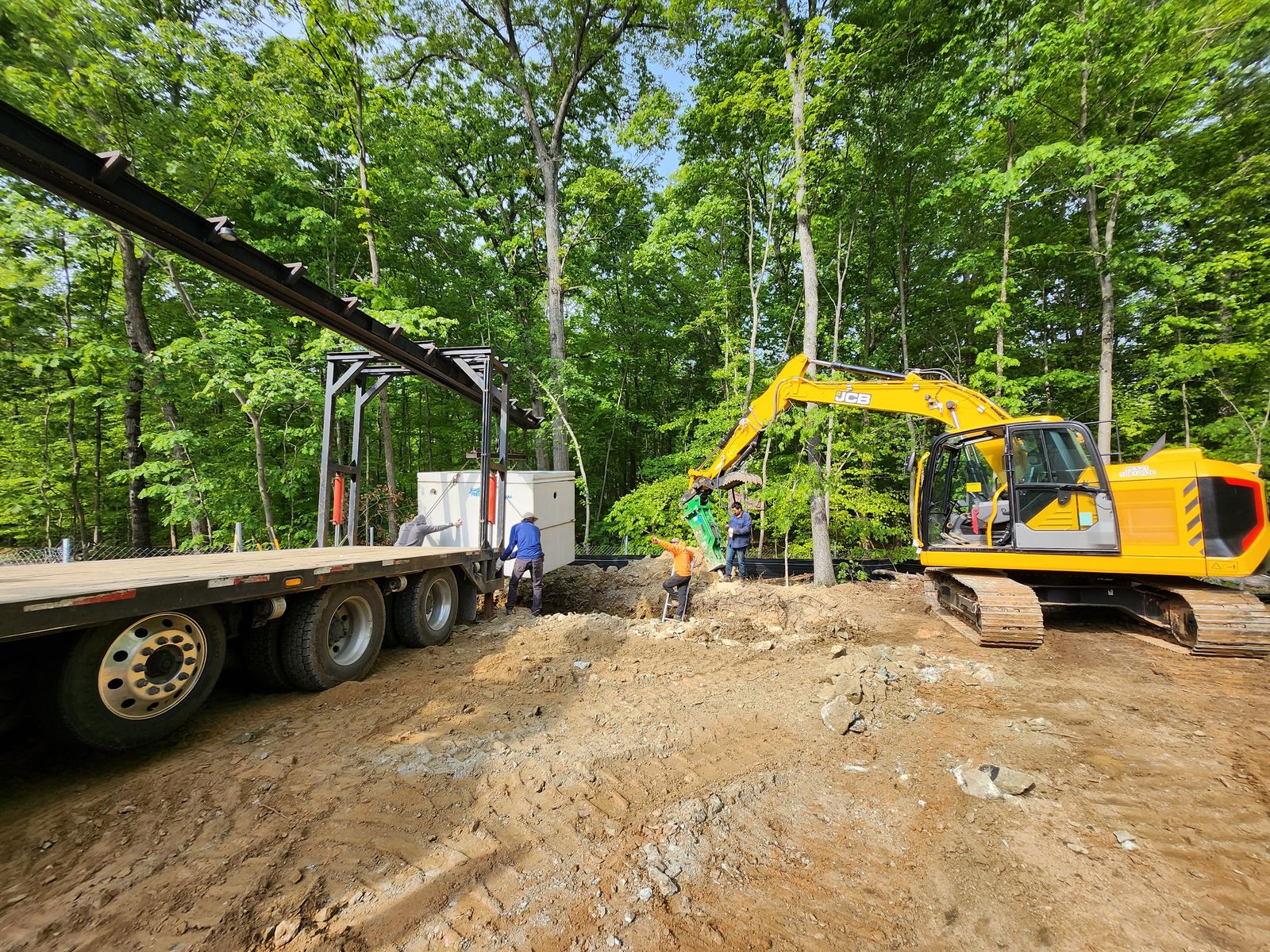 Site work and material delivery using crane and excavator