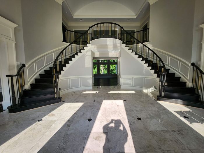 Double staircase and entry hall of the completed residence