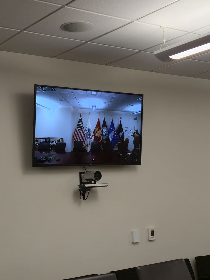 Wall-mounted display installed as part of room fit-out